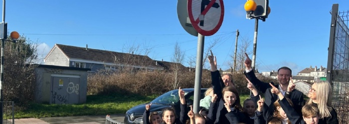 Marine Academy Primary pupils  out by the side of the road with MP Fred Thomas learning about road safety.